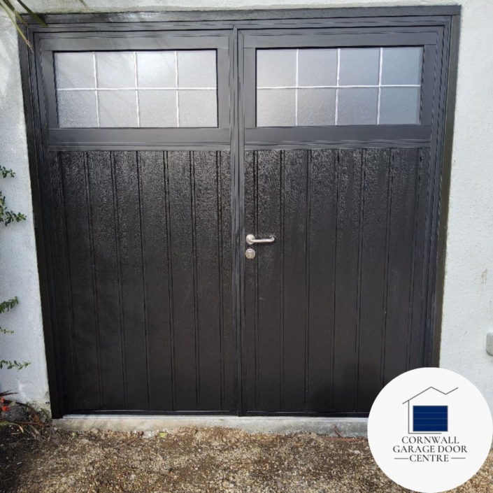Vertical design Teckentrup Traditional Side Hinged Garage Doors with mock lead effect windows, showcasing elegant Black Woodgrain finish. The doors provide a classic aesthetic with modern functionality for your garage space.