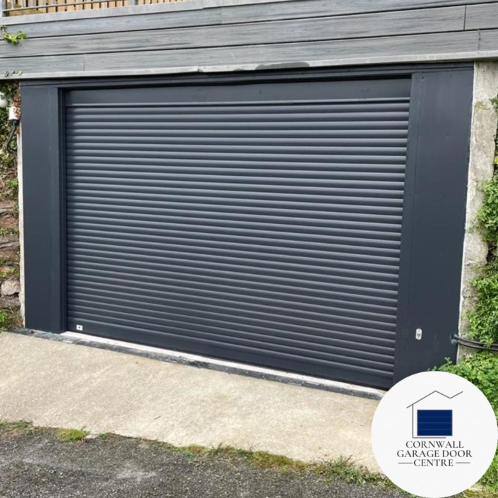 A sleek Anthracite grey SWS Compact roller garage door, featuring a 90-degree fascia for a seamless finish. The low-level external release adds convenience and functionality to the design. This modern garage door exudes style and functionality, enhancing the aesthetics of any home.